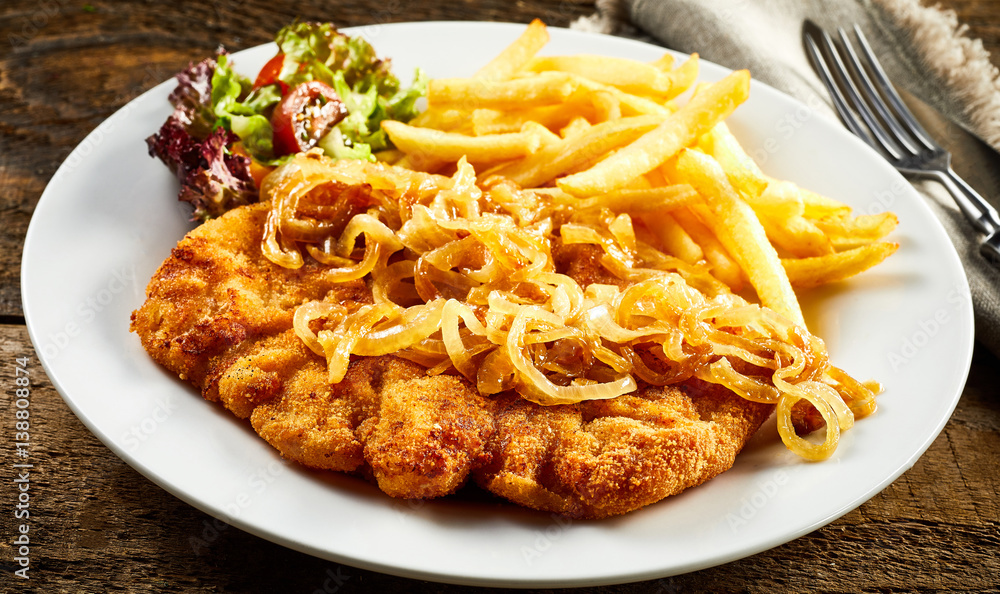Schnitzel with onion and french-fries Schnitzel with onion and french-fries