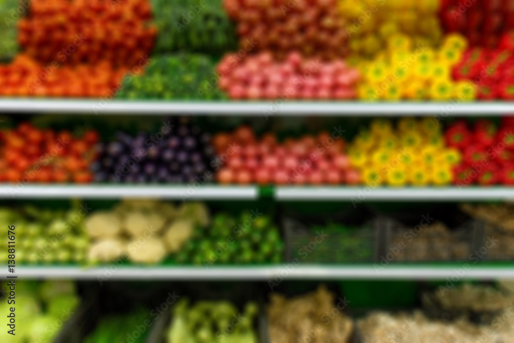 Fresh organic Vegetables and fruits on shelf in supermarket, farmers market. Abstract blurred supermarket aisle with colorful shelves and unrecognizable customers as background