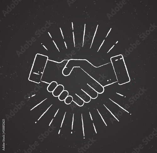 Handshake with sunburst on chalkboard