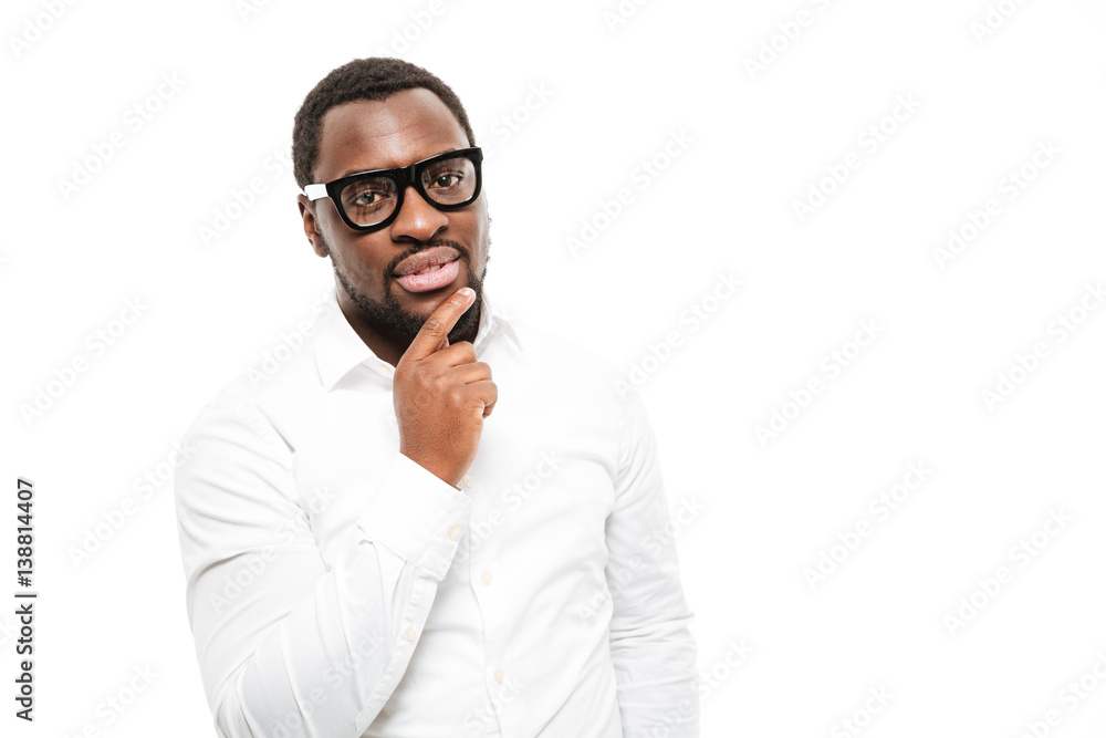 Serious young african man standing isolated over white background. Serious young african man standing isolated over white background.