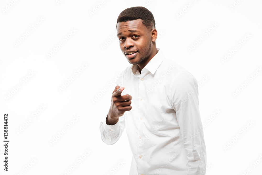 Cheerful young african man pointing to camera. Cheerful young african man pointing to camera.