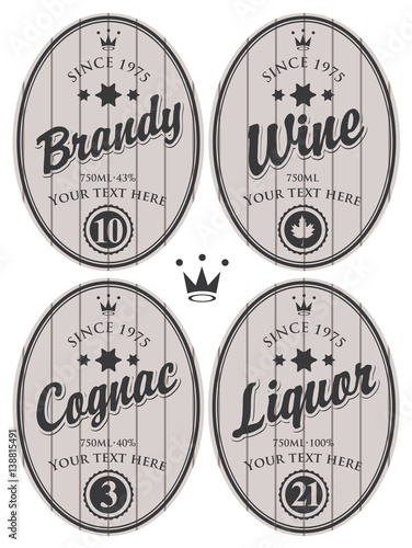 set of oval labels for brandy, cognac, wine, liquor on a gray background, striped with crown