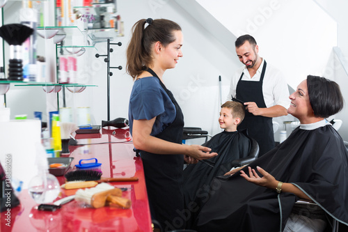 Young woman hairdresser talking to female client