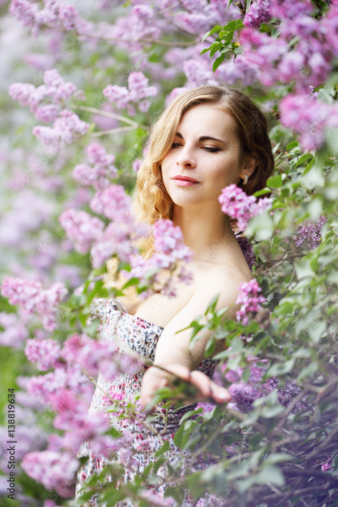 young woman smelling a lilac young woman smelling a lilac