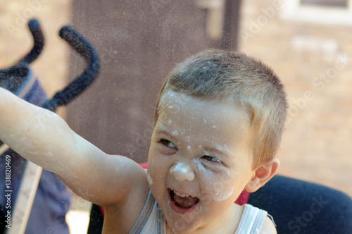 Boy throws the flour until