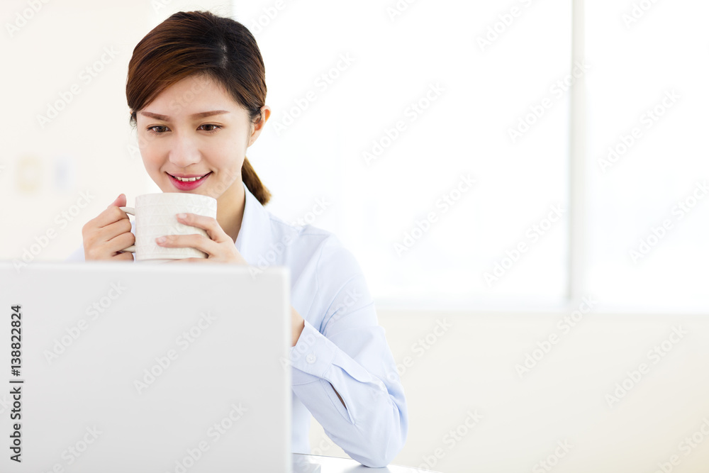 Young business woman with laptop in the office Young business woman with laptop in the office