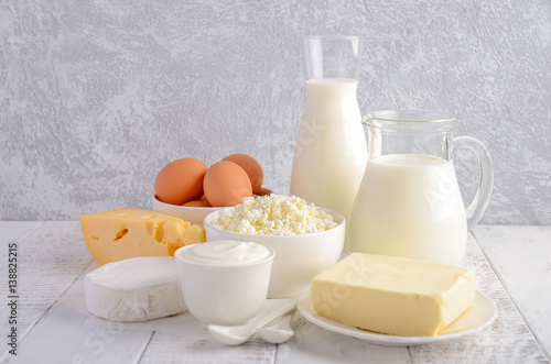 Fresh dairy products. Milk, cheese, brie, Camembert, butter, yogurt, cottage cheese and eggs on wooden table.