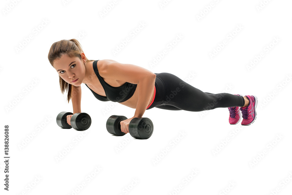 Pretty fitness trainer doing push-ups in studio Pretty fitness trainer doing push-ups in studio