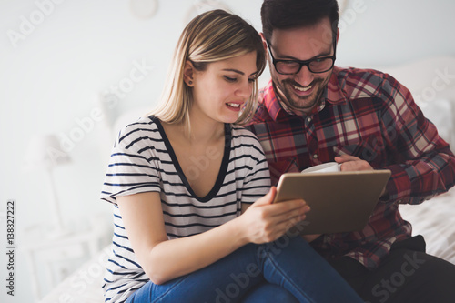 Couple surfing the web on tablet and smiling © NDABCREATIVITY