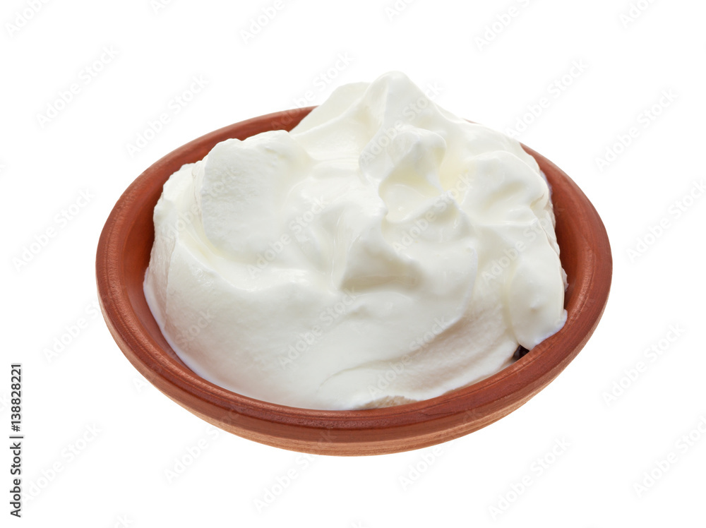 Sour cream in a small bowl isolated on a white background. Sour cream in a small bowl isolated on a white background.