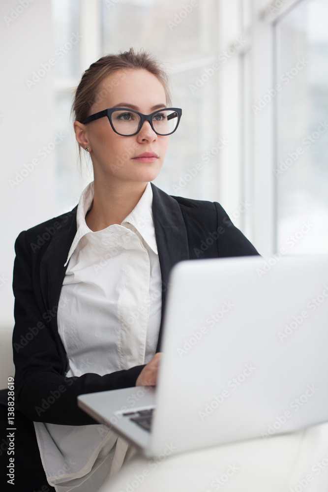 Young woman working at lap top in the office. Young woman working at lap top in the office.