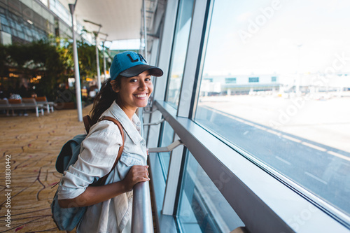 Young woman at airport waiting for airplane