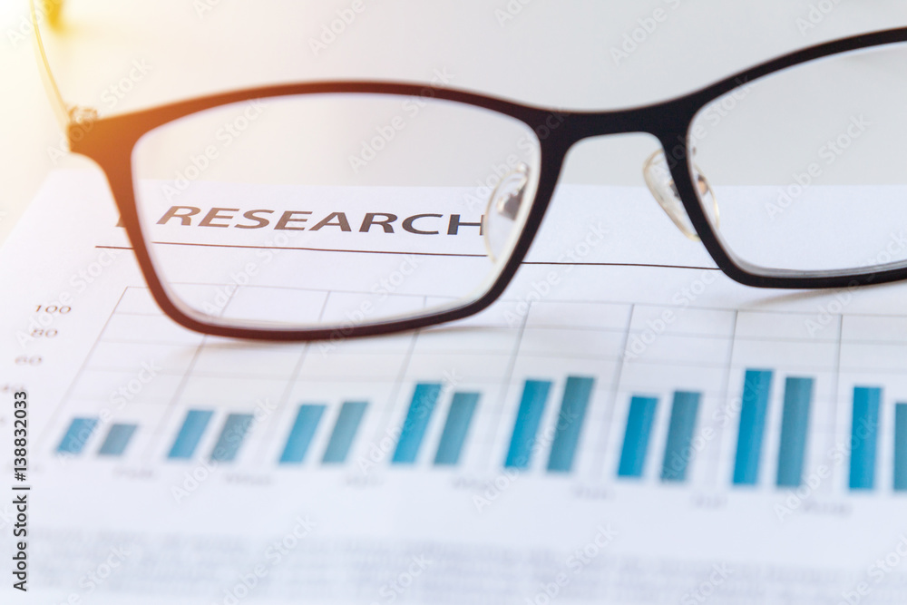 Close up view of glasses on business marketing report meeting and briefing Close up view of glasses on business marketing report meeting and briefing