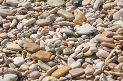 Close up photo of pebble stones in the sun 