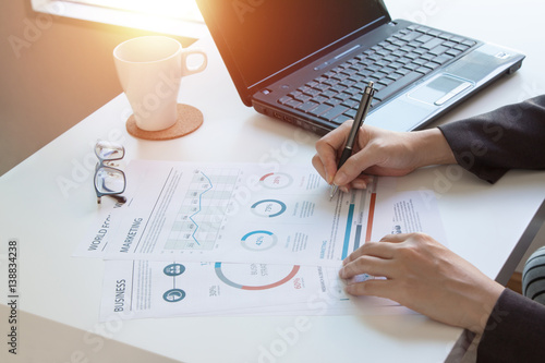 Wallpaper Mural business documents on office table with laptop computer and graph financial diagram and Business people working at office Torontodigital.ca