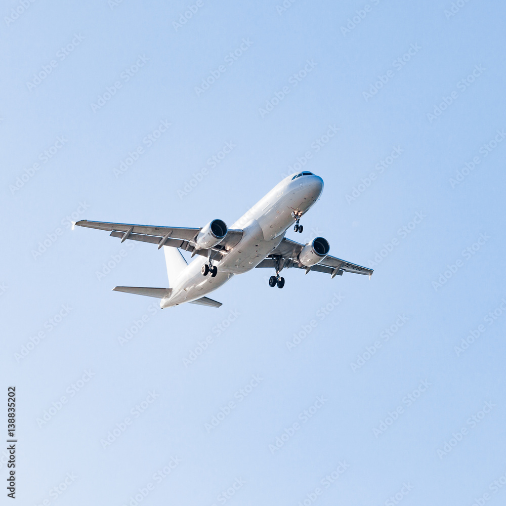 white airplane on a blue background. airplane in the sky white airplane on a blue background. airplane in the sky