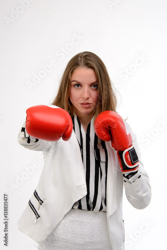 Young business woman with boxing gloves
