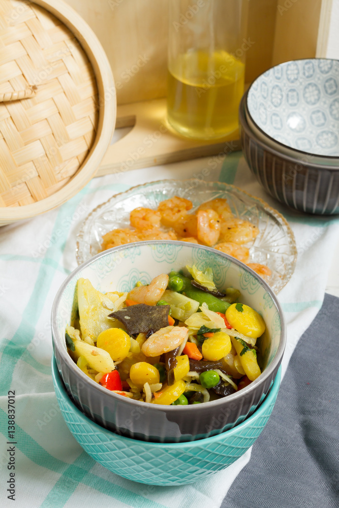 Asian food with vegetables and shrimps. Sesame oil, bowls, bamboo steamer. Asian food with vegetables and shrimps. Sesame oil, bowls, bamboo steamer.