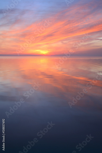 Coastal Sunset, Clouds Reflecting in the Calm Sea