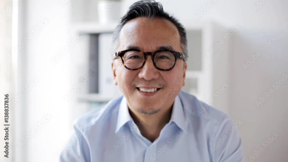 happy smiling asian businessman at office