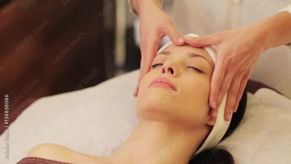 woman having face and head massage at spa woman having face and head massage at spa