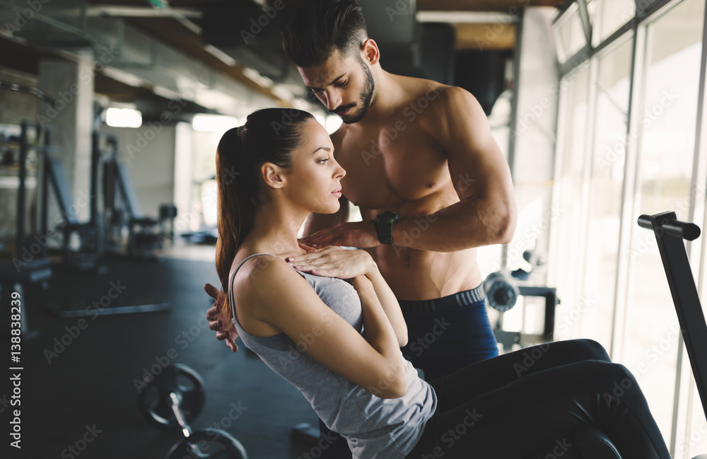 Personal trainer helping woman reach goals Personal trainer helping woman reach goals