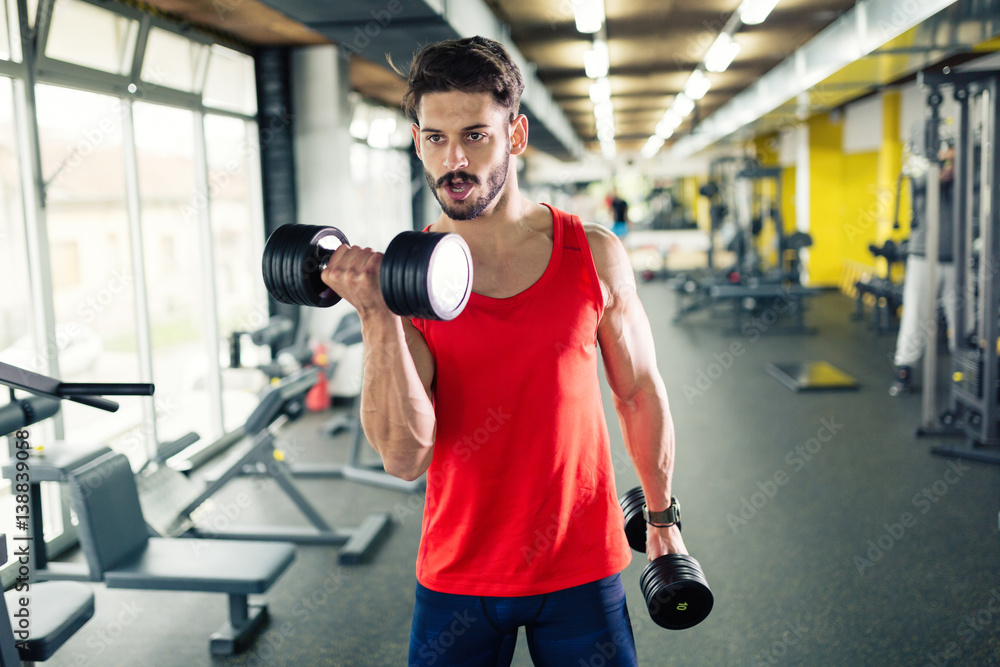 Determined male working out in gym Determined male working out in gym