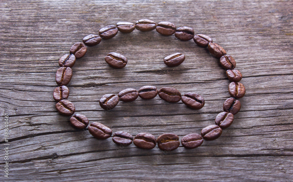 KIEV, UKRAINE - February 21, 2017: sad smiley of coffee beans KIEV, UKRAINE - February 21, 2017: sad smiley of coffee beans
