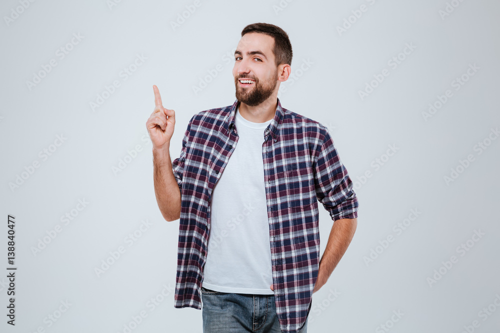 Funny Bearded man in shirt pointing up Funny Bearded man in shirt pointing up