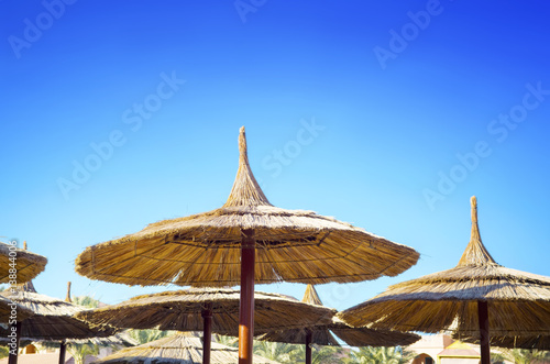 Fototapeta Naklejka Na Ścianę i Meble -  Sunshades in the blue sky in Hurghada background