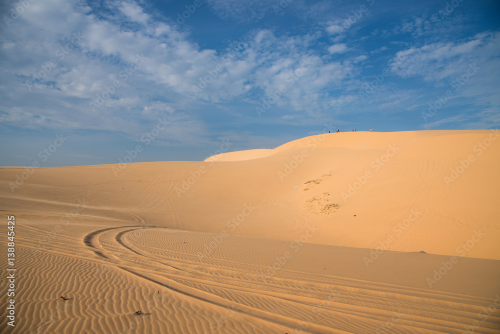 Naklejka premium White sand dune in Mui-Ne city on blue sky background, Vietnam Feb 2017