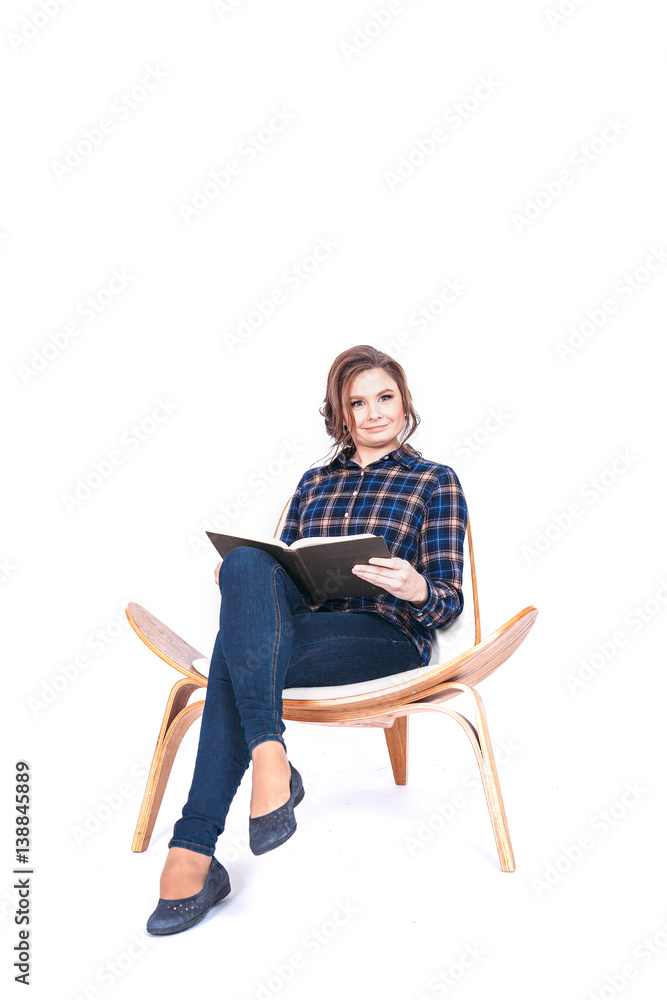 Full length portrait of siting beautiful woman student holding book isolated on a white background