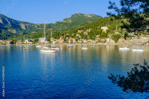 Boats moored in the evening sun in the bay at Port De Soller Majorca Spain
