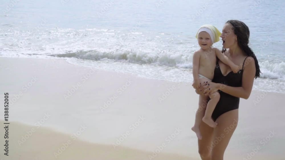 Mother and daughter are singing on the beach Mother and daughter are singing on the beach