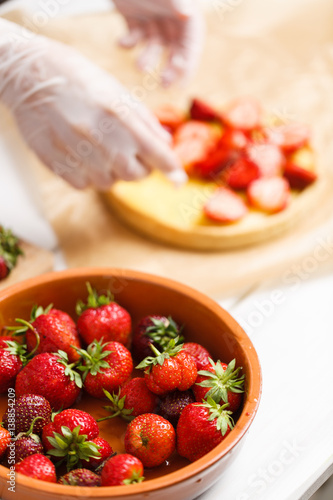 decorating fresh strawberry tart