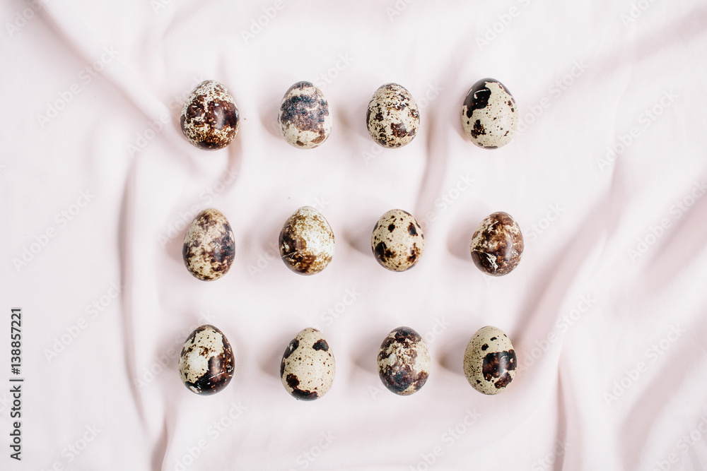 Quail eggs on pink textile background. Flat lay, top view. Easter concept. Quail eggs on pink textile background. Flat lay, top view. Easter concept.