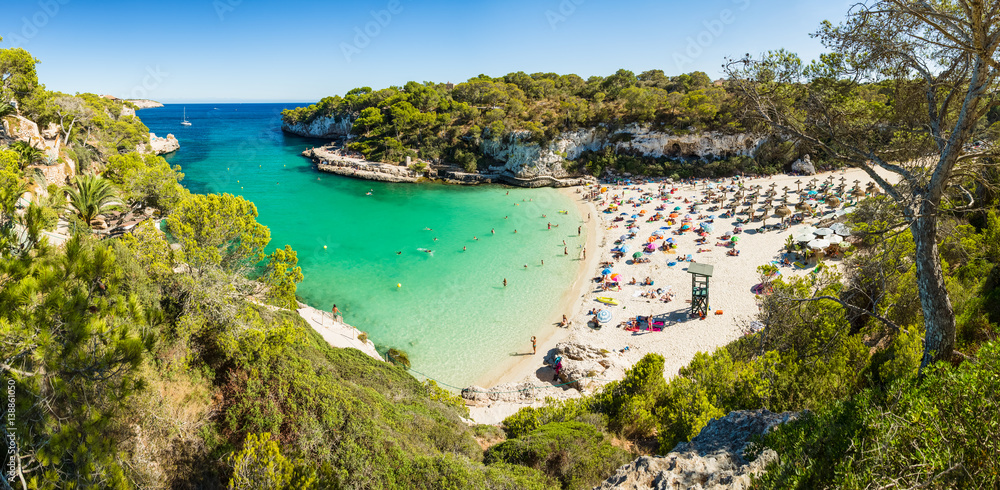 Panoramic view of Cala Llombards beach. Beautiful sandy beach that is sheltered on either side by cliffs. Mallorca island, Spain.