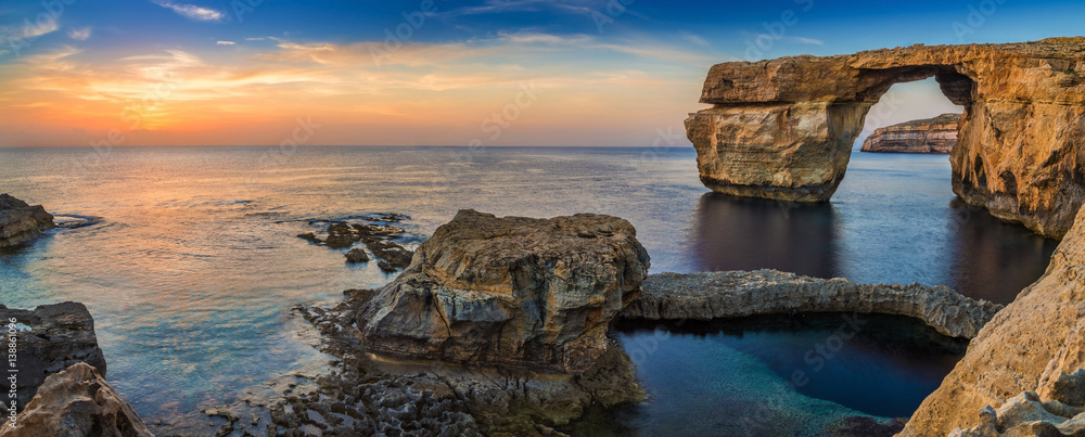 Fototapeta premium Gozo, Malta - Panoramic view of the beautiful Azure Window, a natural arch and famous landmark on the island of Gozo at sunset