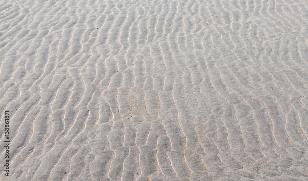 Ripple patterns left is sandy beach by receding tide. Ripple patterns left is sandy beach by receding tide.