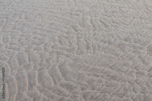 Ripple patterns left is sandy beach by receding tide.