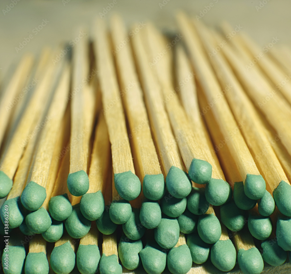Matchsticks with green tips on a birch board macro close up Matchsticks with green tips on a birch board macro close up