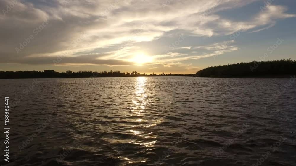 Scenic landscape. View on a riverbank from a boat riding on the river Volga at sunset. 4K Scenic landscape. View on a riverbank from a boat riding on the river Volga at sunset. 4K