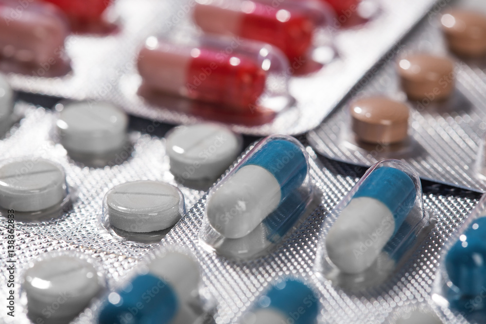 Pile of medical tablets and pills in silver plastic boxes Pile of medical tablets and pills in silver plastic boxes