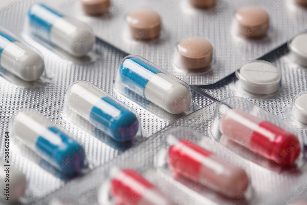 Pile of medical tablets and pills in silver plastic boxes Pile of medical tablets and pills in silver plastic boxes