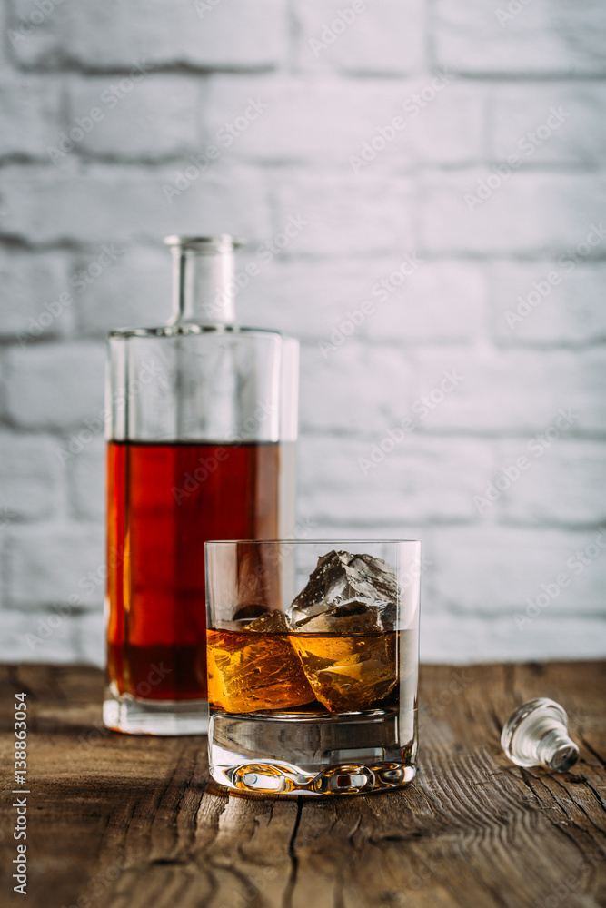 Glass of whiskey on a wooden table Glass of whiskey on a wooden table