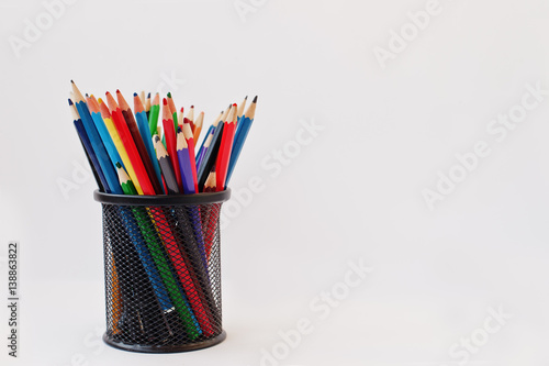 Fotografia Colored pencils in black pencil case  isolated on white background
