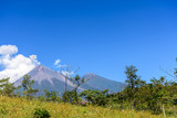 Active Fuego volcano puffs smoke with Acatenango volcano behind in Escuintla, Guatemala, Central America
