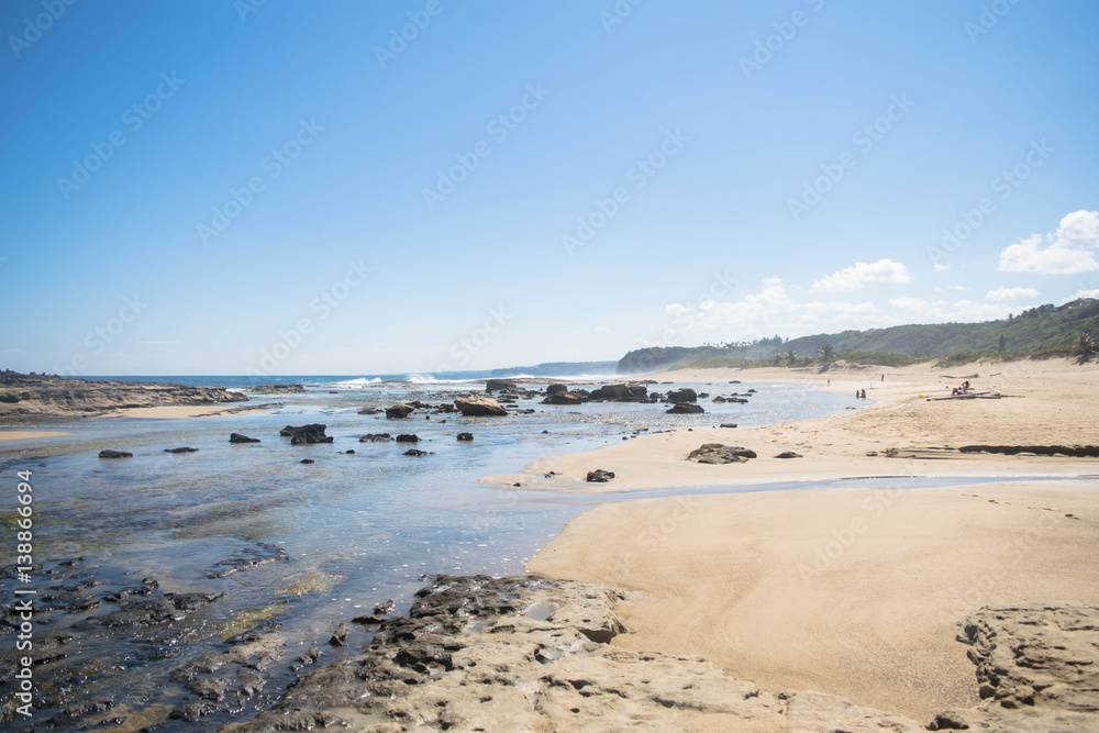 Seascape: beach, rocks and blue sky