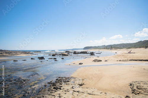 Seascape  beach  rocks and blue sky