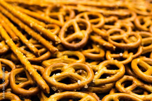 Background texture of salted salty pretzels and mini sticks in the traditional form of the hinge assembly
